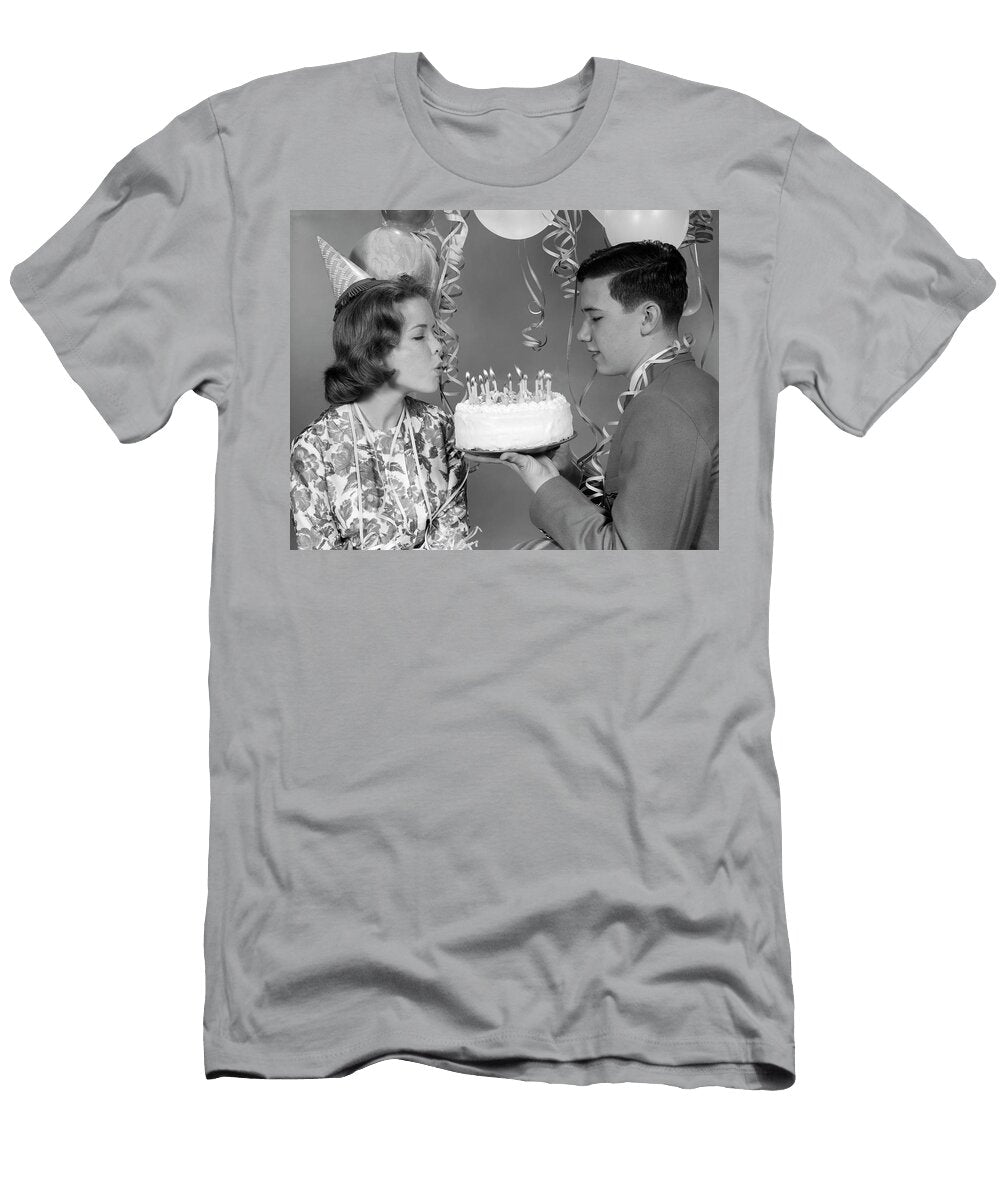 1960s Teenage Girl Blowing Out Candles on Birthday Cake Held By Boy Panoramic Images T-Shirt